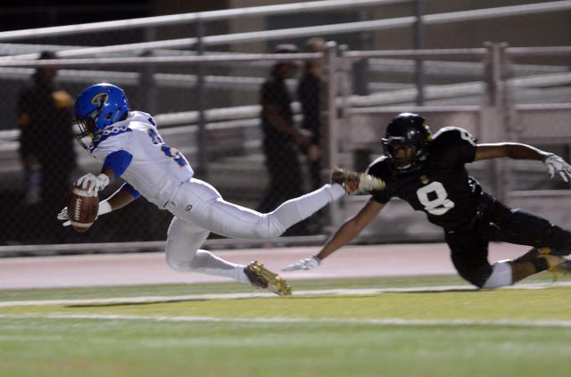 Serrano's Sultaan Sullivan (left) dives to the pylon ahead of Rubidoux's Robert Taylor in Week 12. / Photo for Victorville Daily Press