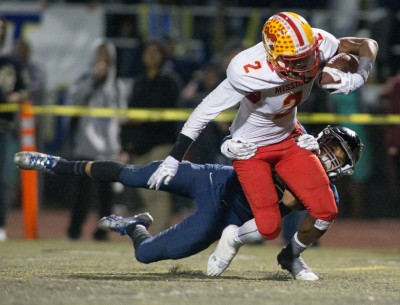 Mission Viejo's Olaijah Griffin breaks away from a Vista Murrieta tackler on Friday, Dec. 4, 2015. / Photo for The Press-Enterprise